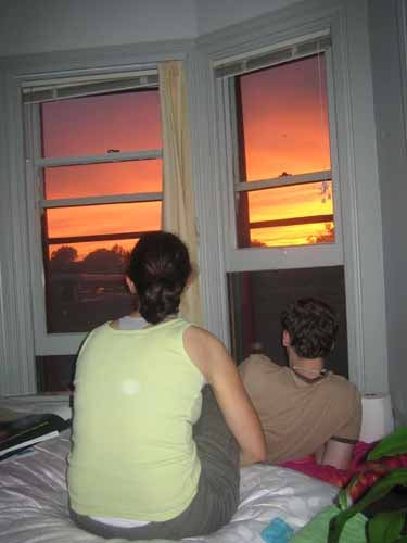 Looking out the window at a beautiful sunset.