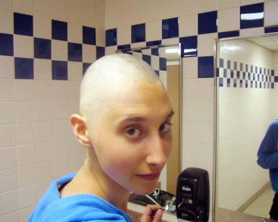 Aries in front of the bathroom mirror with a freshly shaved head.