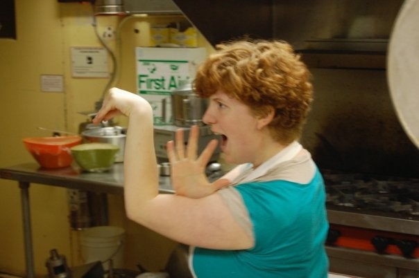 A student dances in a kitchen