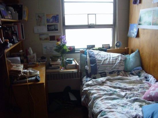A small dorm room with lots of stuff in it, yet it is kept relatively neat and clean