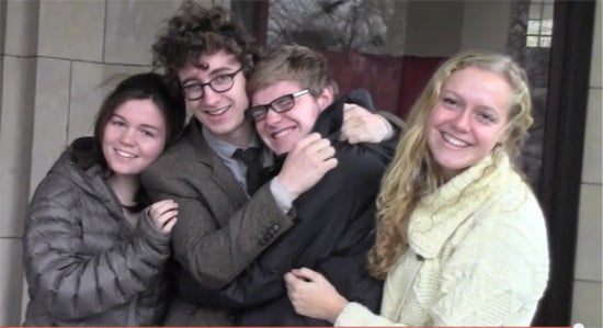 Four siblings embracing aand posing for the camera