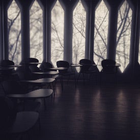 Empty classroom with eerie winter light coming in through the iconic vertical windows.