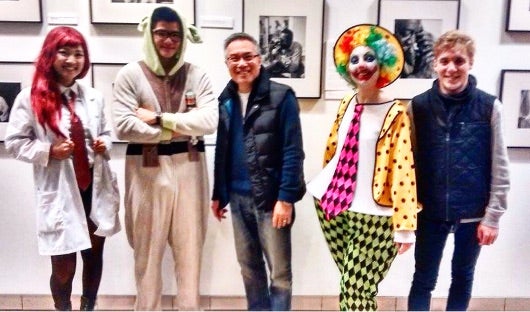 Students in costume with the professor, not in costume