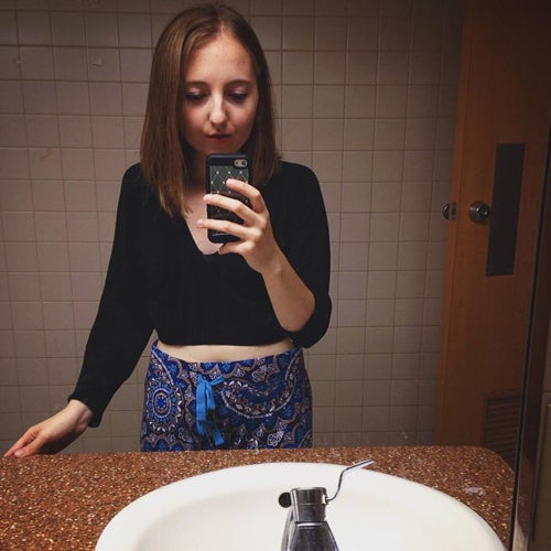 Someone takes a selfie in a bathroom mirror