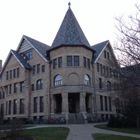 A multi-gabled sandstone building in the Richardsonian Romanesque style