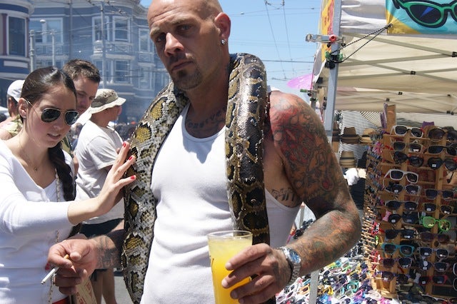 A man with a snake around his neck
