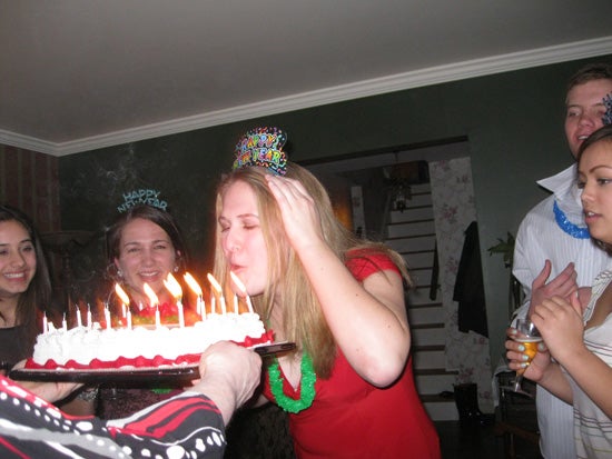 The birthday girl blows out candles on a cake.