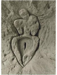 a stone carving of a simplistic woman