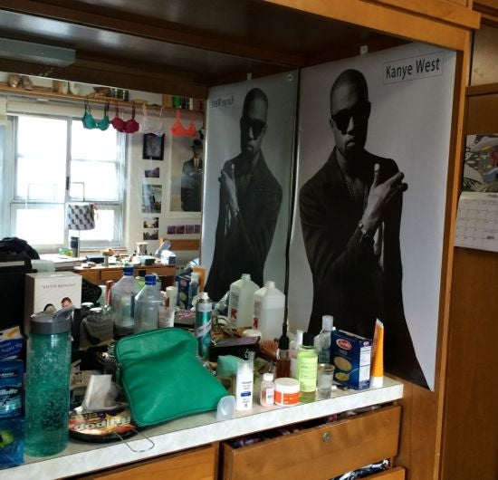 A poster of Kanye above the dresser