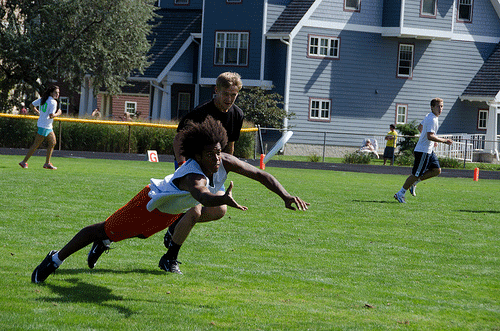 Player mid-air diving for a frisbee 