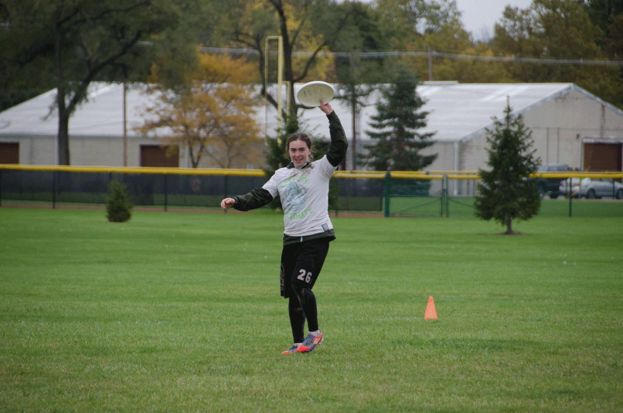 Player triumphantly holds a frisbee in the air