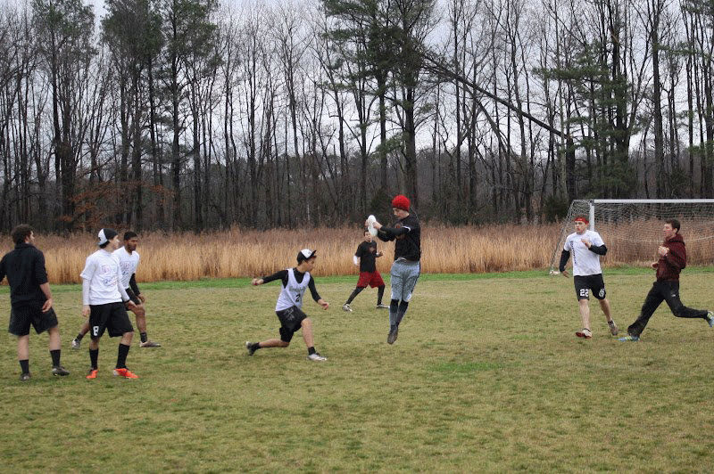 Player jumping up with a frisbee in his hands