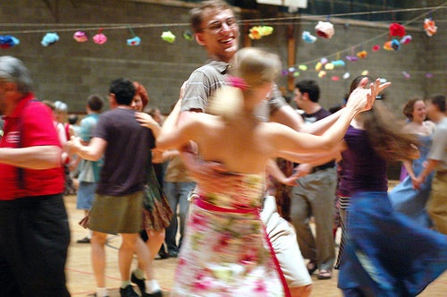 A boy and a girl dancing in a crowd