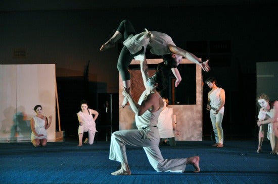 Students performing with one propelling another into the air 