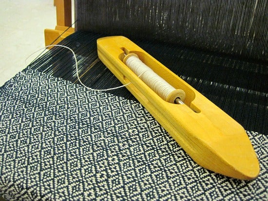 The sewing shuttle used to make the pattern