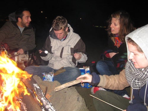 A group sits around a fire