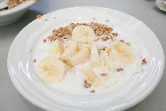 One bowl of yogurt, granola, and sliced banana