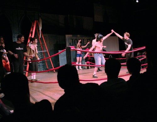 Students perform in a boxing ring 
