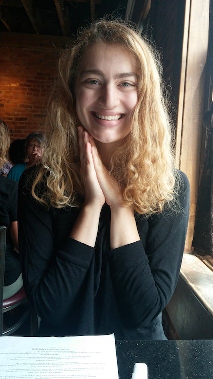 Karalyn at a restaurant table with a huge smile