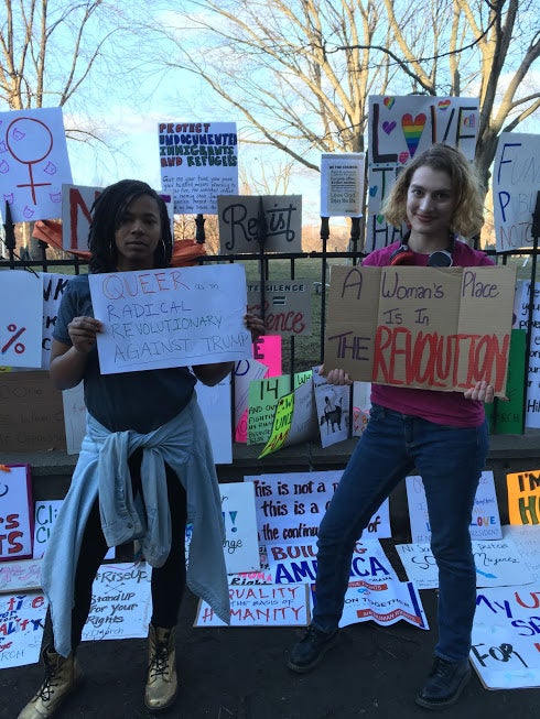 Two students holding protest signs 