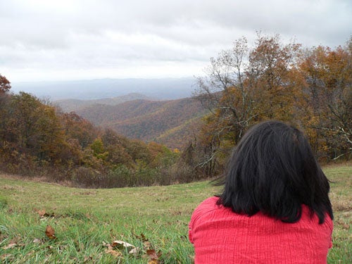 Student gazing at a mountainous valley