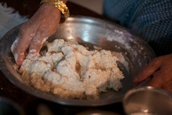 Hands knead dough 