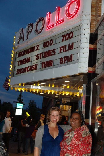 Two women pose in front of the Apollo 