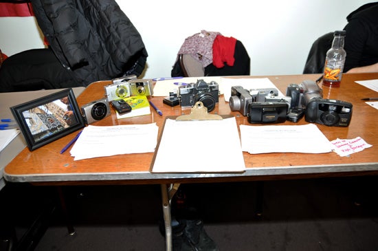 Cameras and a sign up sheet on a table