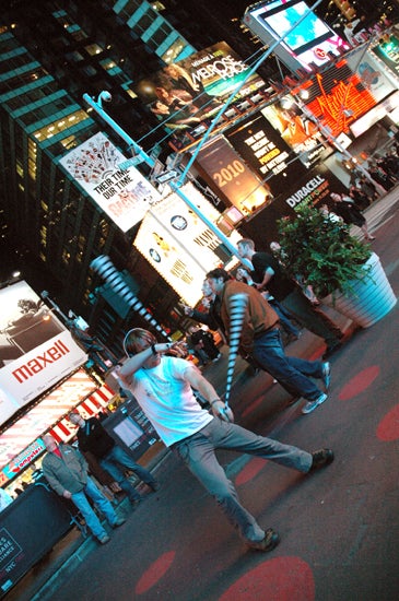 A student spins poi in Times Square