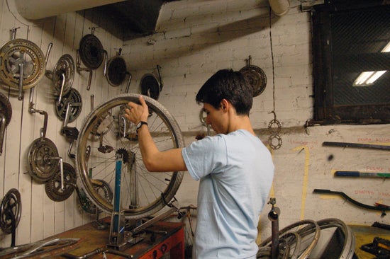 A student repairs a bike wheel 