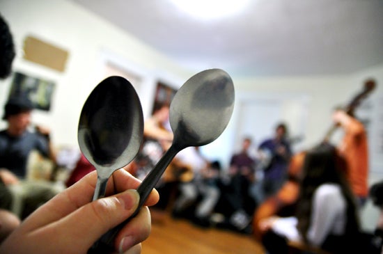 Photographer holding two spoons 