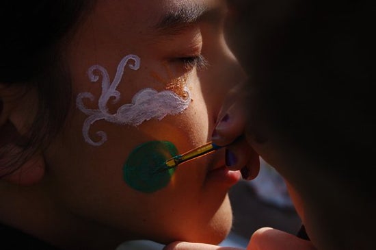 Close-up of face painting Harris's cheek.