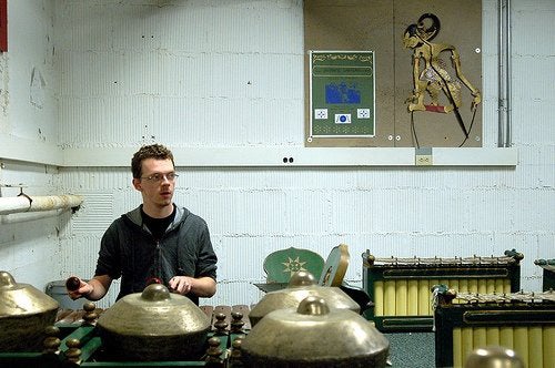 Sean practicing gamelan percussion instruments.