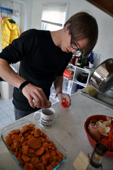 A student adding spices to a mug