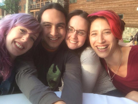 Four happy friends in a group selfie