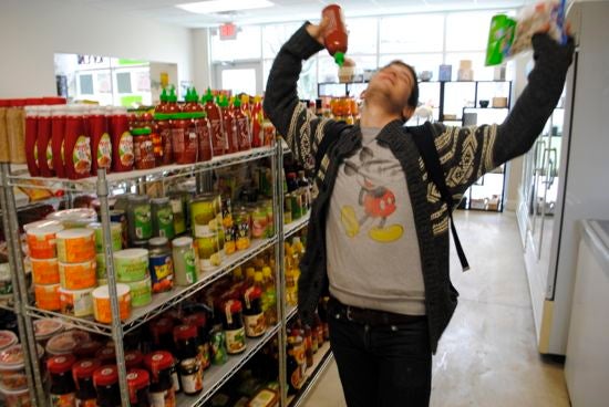 Noah holding Sriracha and jumping in Kims