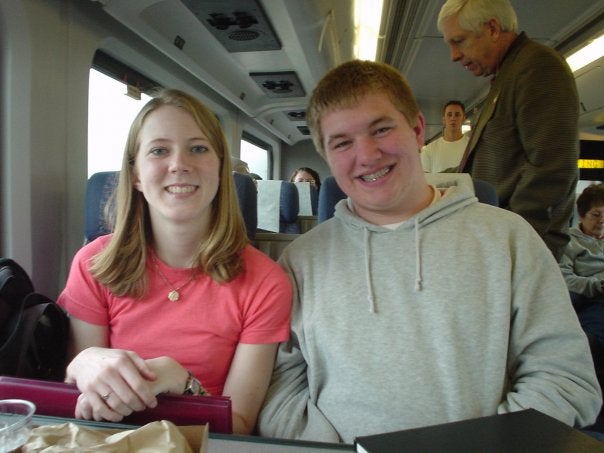 Patrick and Sarah seated on a train