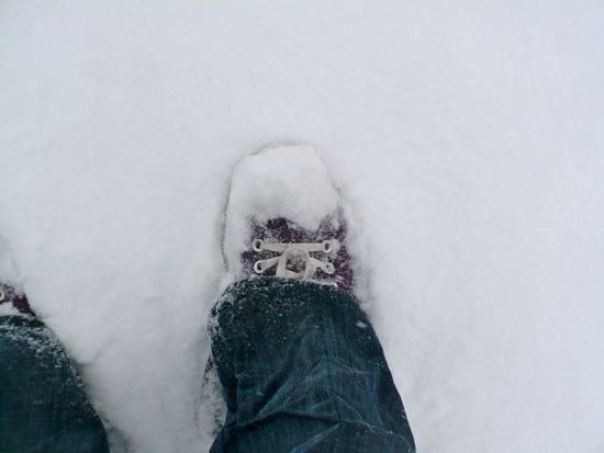 The photographer's shoes buried in snow