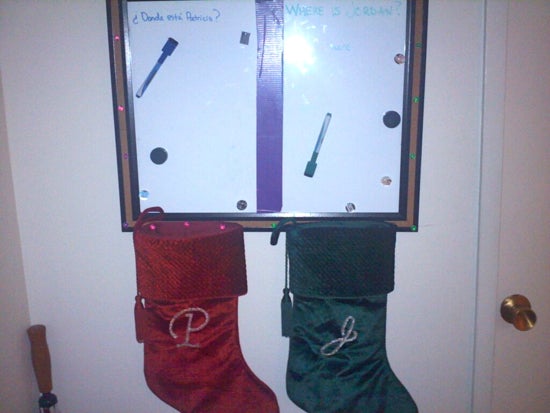 A door with a white board and two stockings 