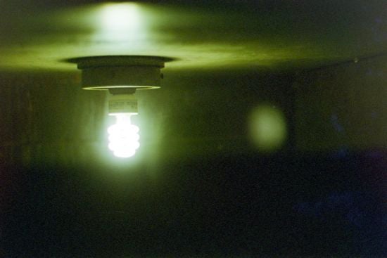 A light bulb shining on a cieling 