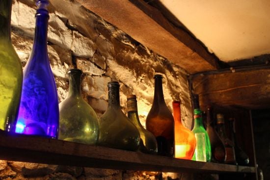 Colorful empty glass bottle on the wall for display
