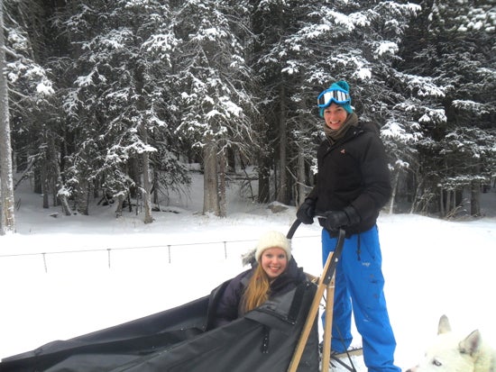 Two students pose for a photo on the dog sled