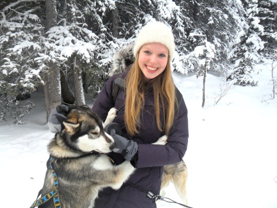 A student poses with a huskie