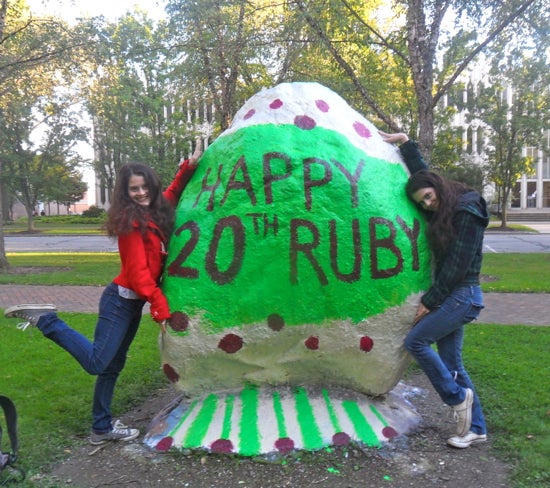 Students hug the spray painted rock 