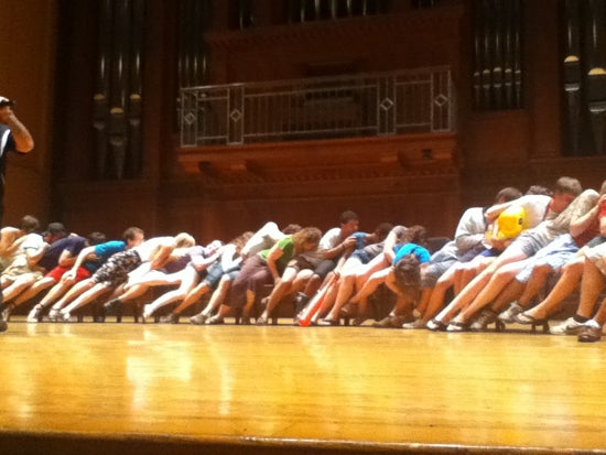 A large group of students in Finney Chapel leaning on eachother