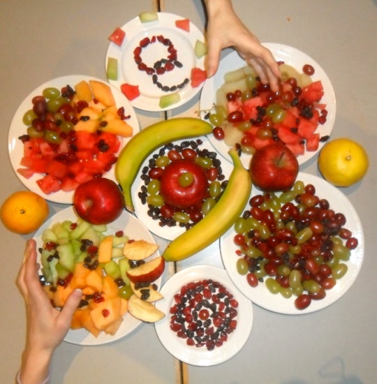 Many plates of different fruits