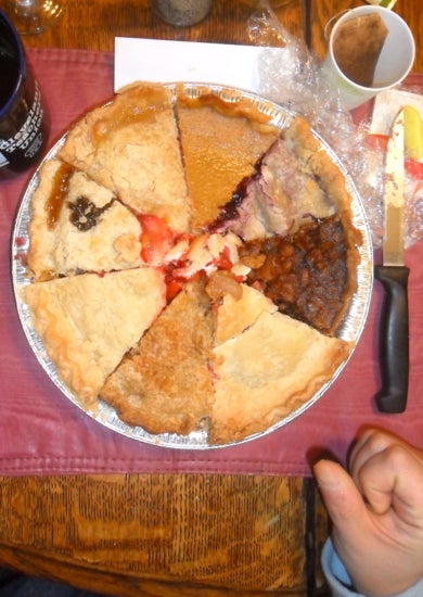 A pie plate filled with different kinds of pie pieces 