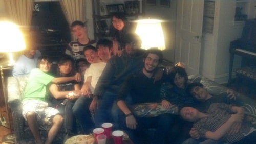 About a dozen people together on a couch