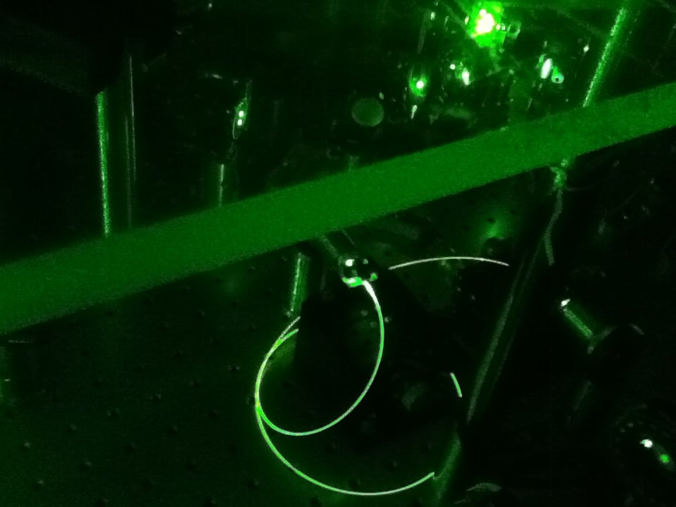 Lab equipment and wires glow green.