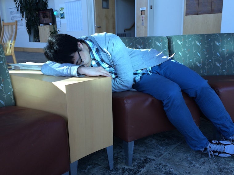 Chul naps on a couch with his head resting on the adjacent table
